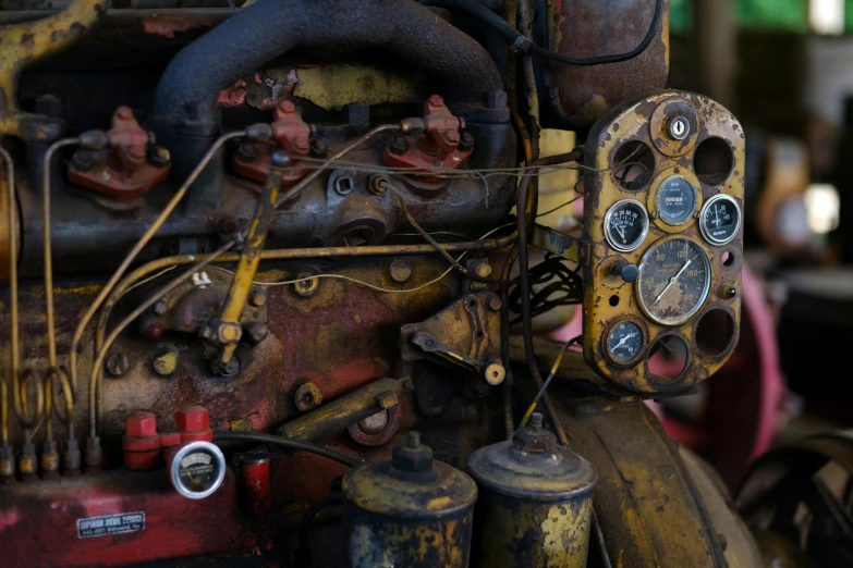 an old engine is seen with other parts and gauges