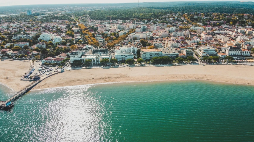 an aerial view of the beach with houses and water