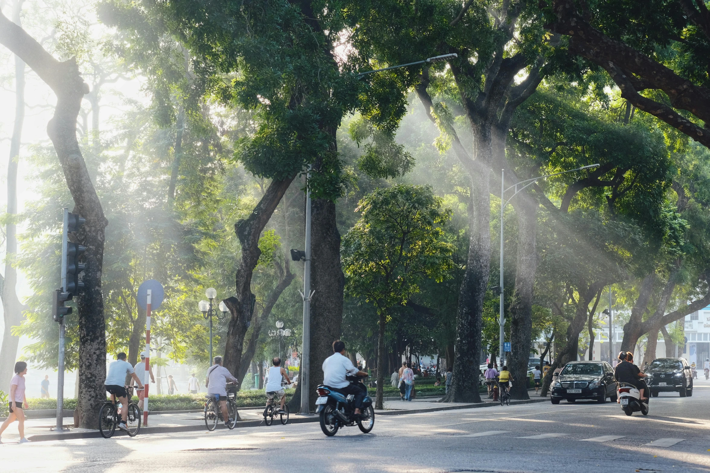 a couple of people on their bikes in the middle of the road