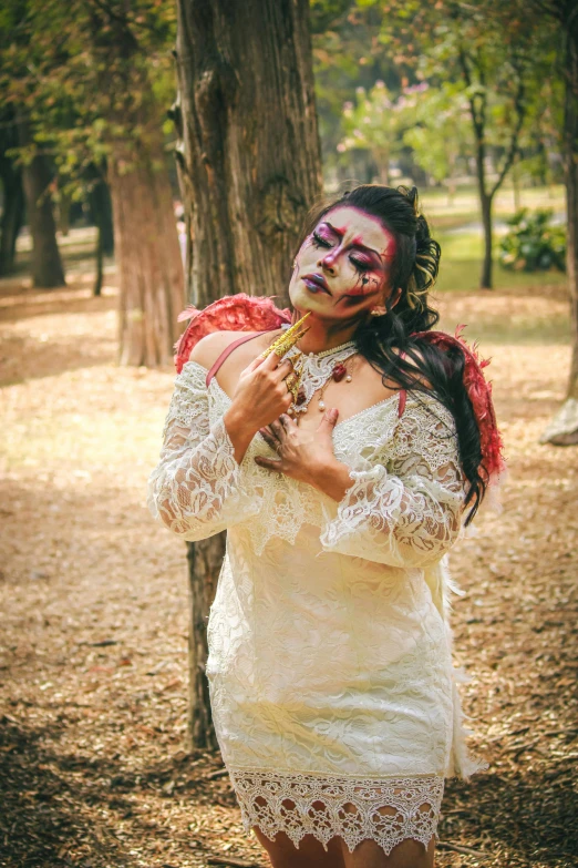 a woman wearing zombie makeup and holding a knife