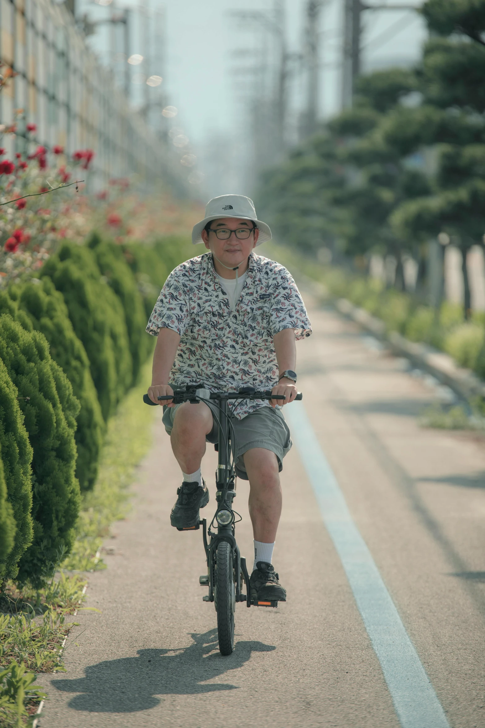 a man on a bicycle is riding down the street