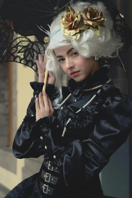 a woman in costume and holding an umbrella