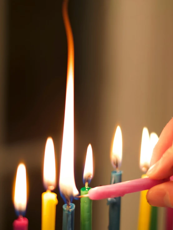 a person that is lighting some candles