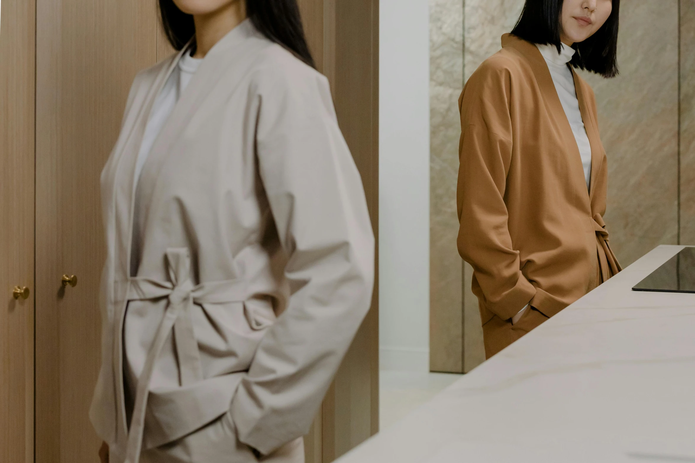 an asian woman standing in front of a wooden door