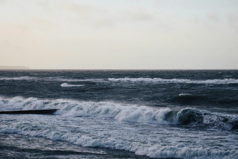 a surfer riding the waves on top of a surf board