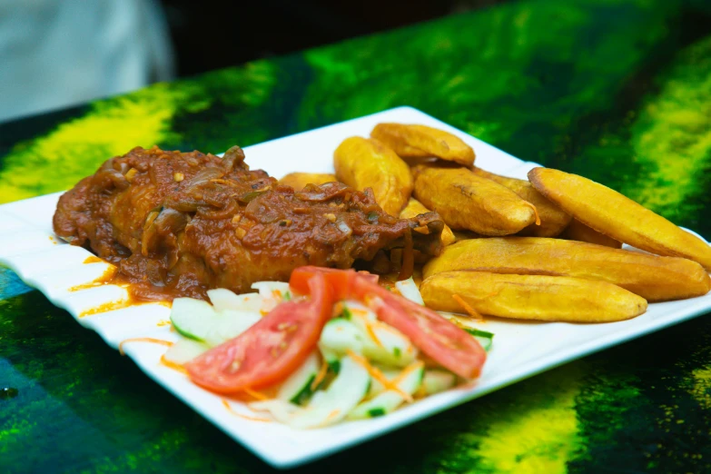 a plate of food sits on a green table