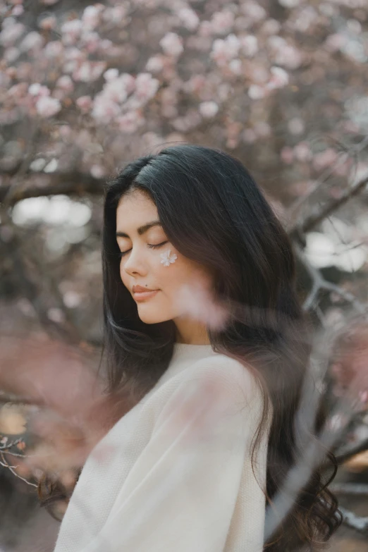 woman with flowers on her head looking into a tree