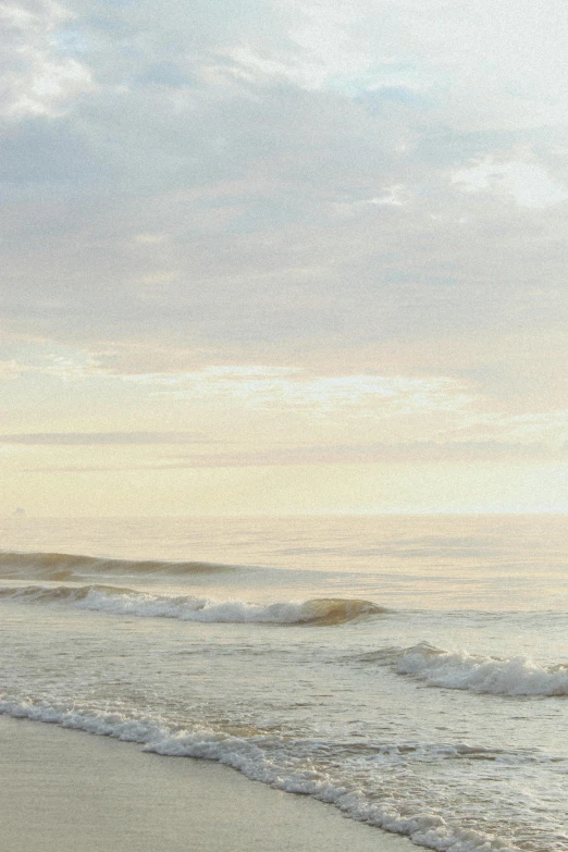 two people walking out to the water at sunset