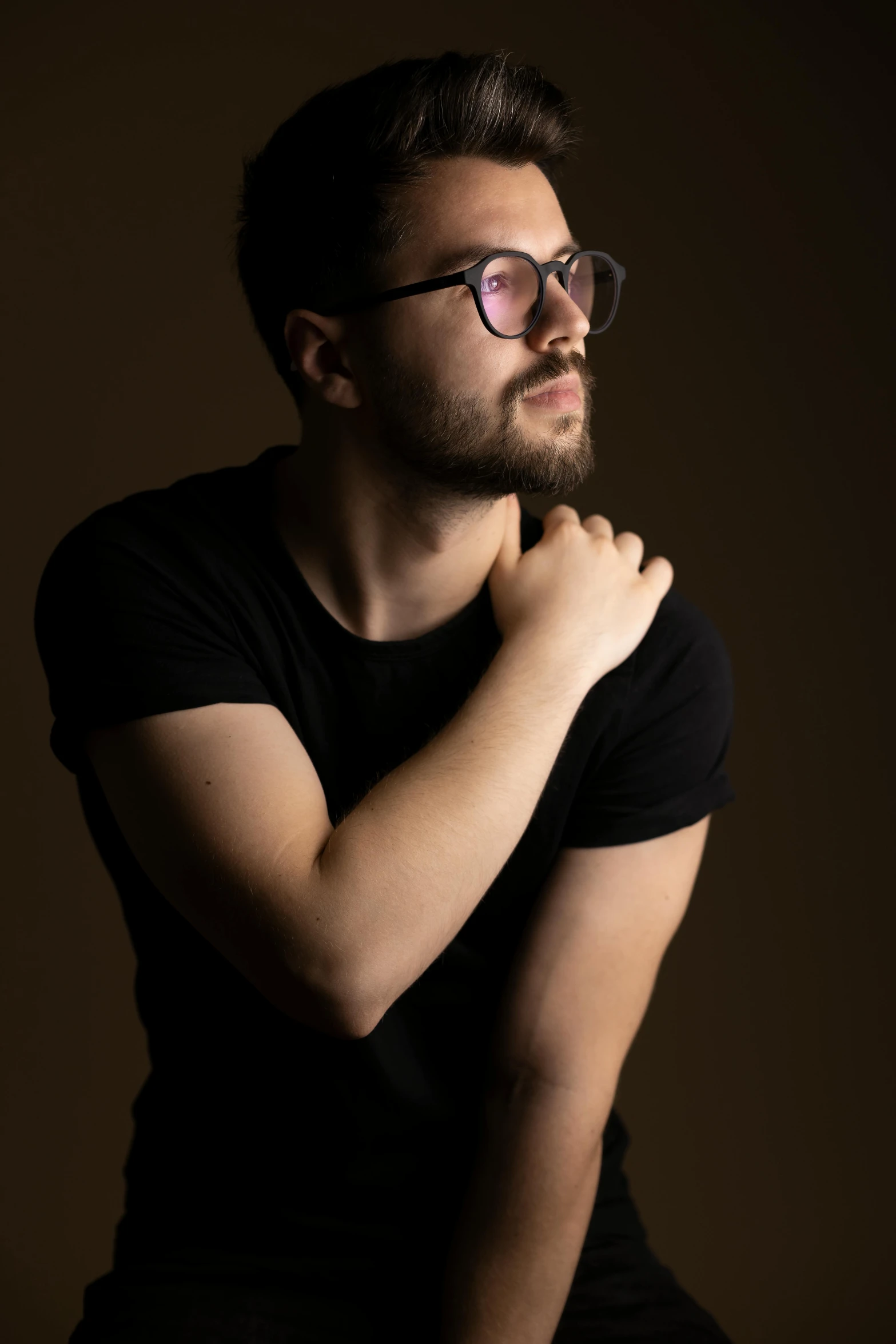 a man with a beard and glasses leaning forward