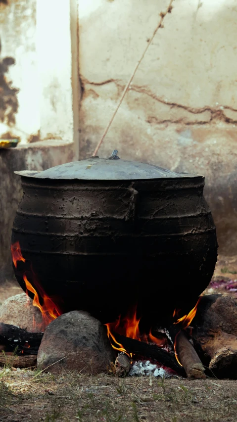 a large pot is on fire with rocks