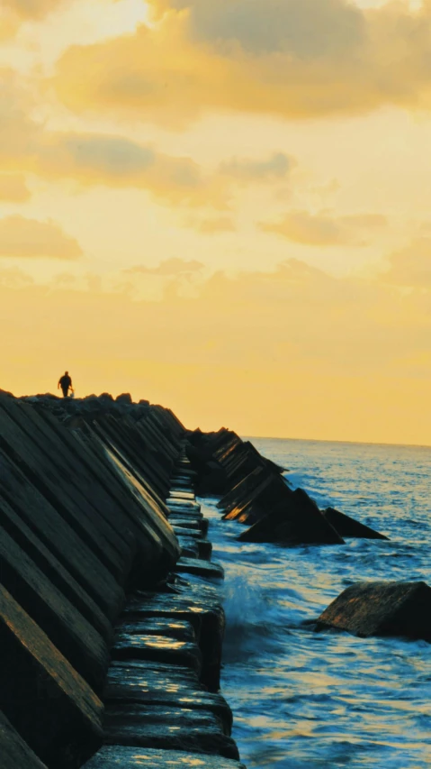 a seawall by the ocean in the sun