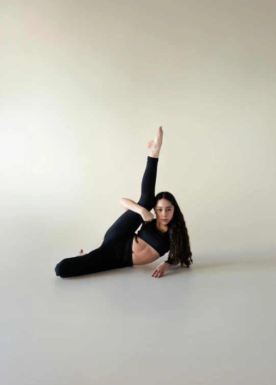 a girl sitting on her stomach posing for a picture