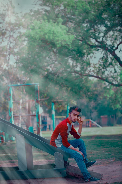 a person on a phone sitting at a playground