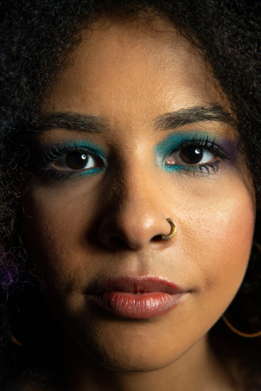 an african american woman with a green eye makeup