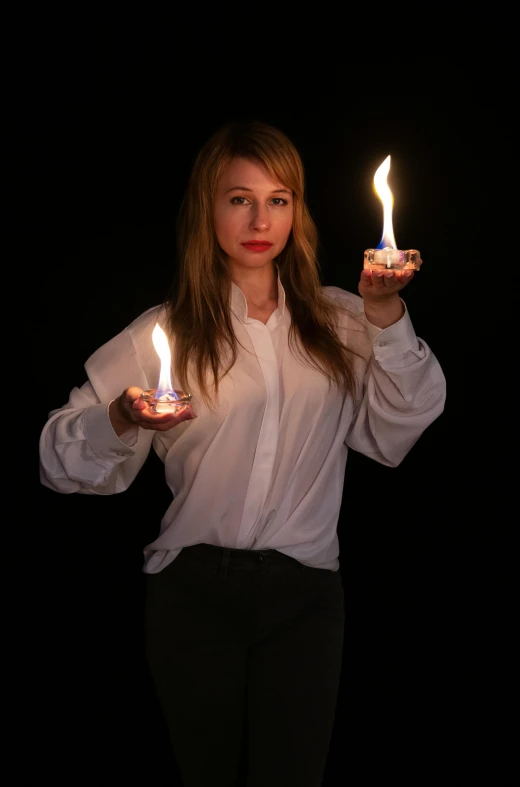 woman in a shirt with candles in hand