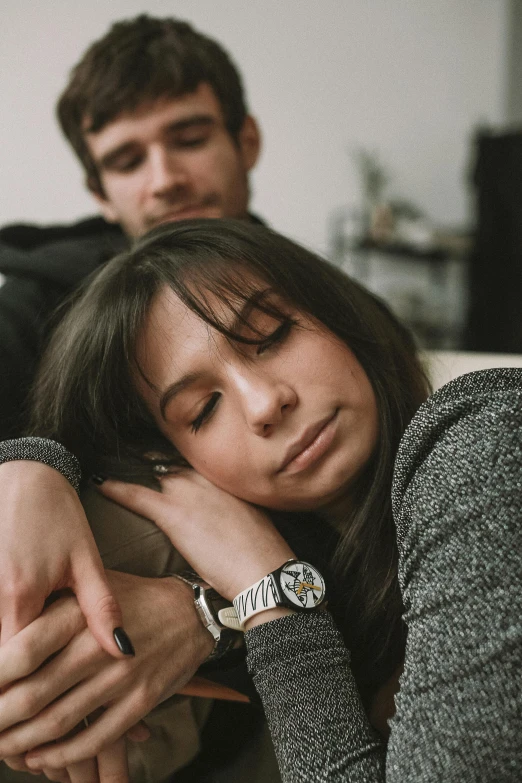 two people, one holding the other's hand while holding a watch