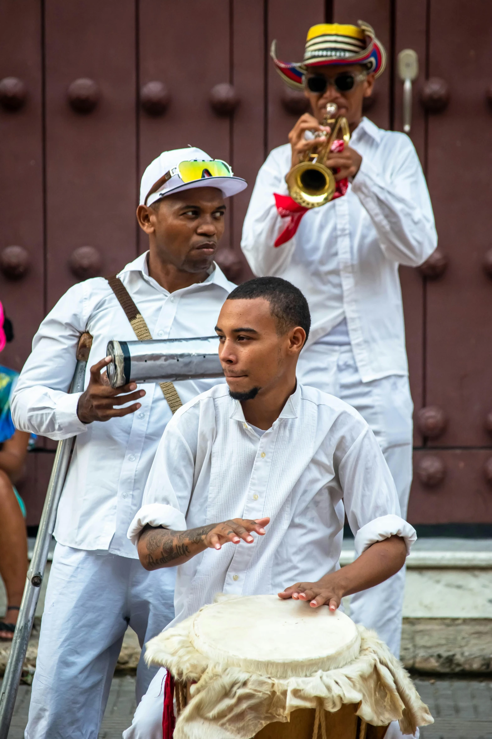 the men are playing music in their outfits