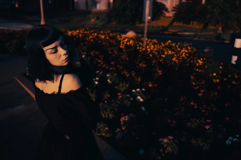 a woman in black dress staring away from the camera