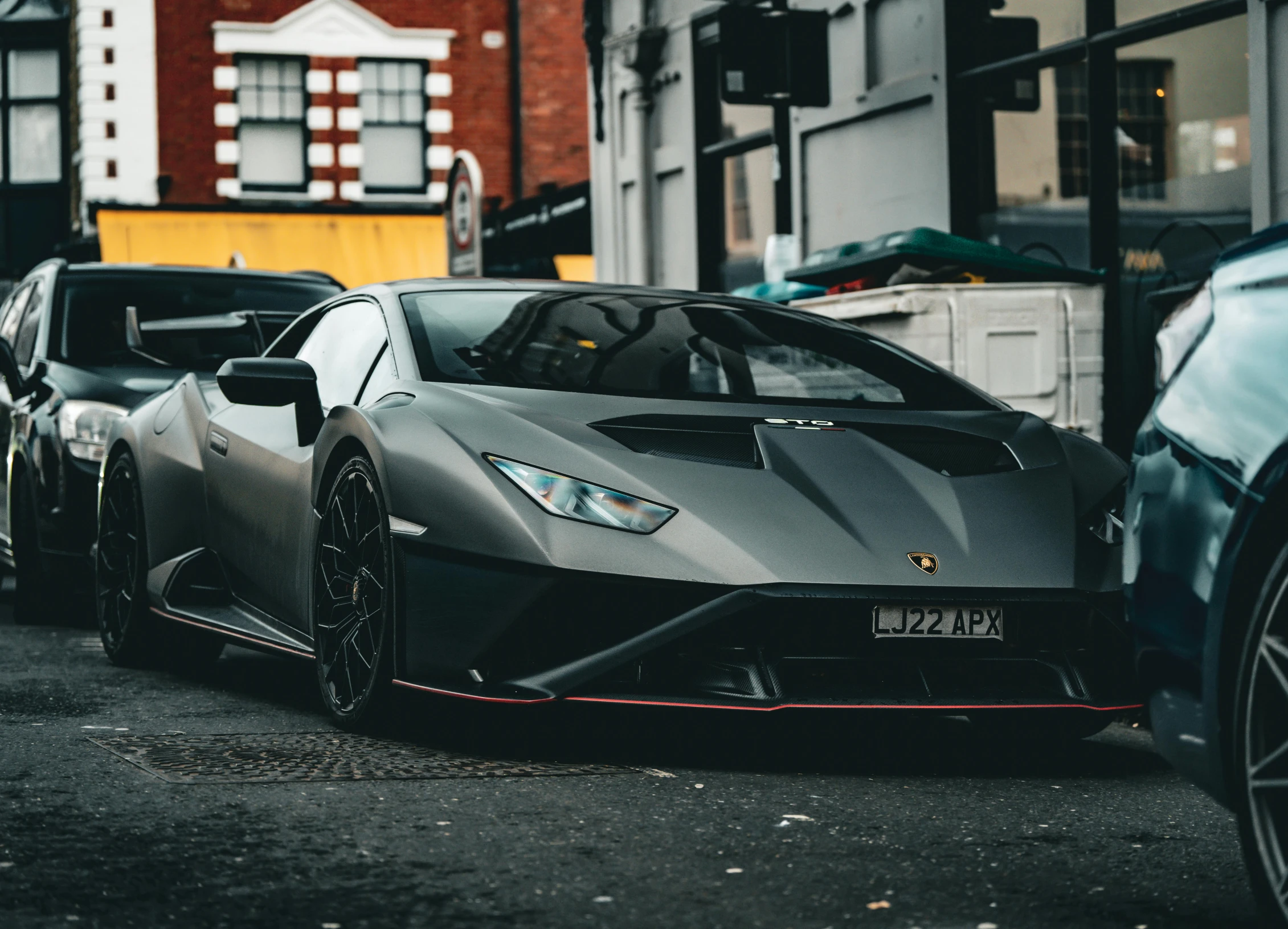 a large black sports car parked on the side of the street