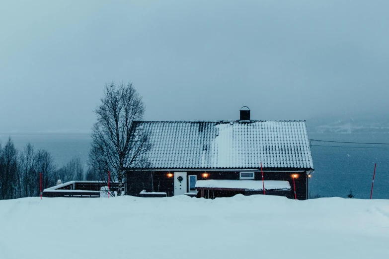 a house that is standing in the snow