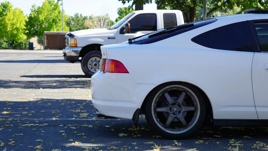 two cars parked side by side in a parking lot