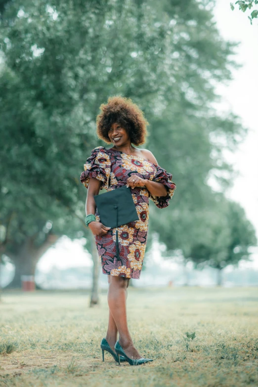 a woman in a dress stands in a field