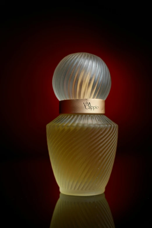 an odd looking perfume bottle that is glowing yellow