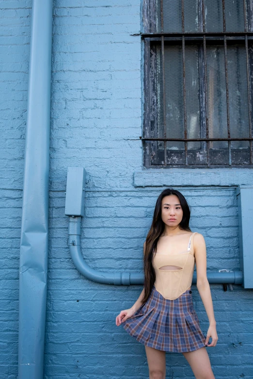 a girl wearing a blue dress posing for the camera