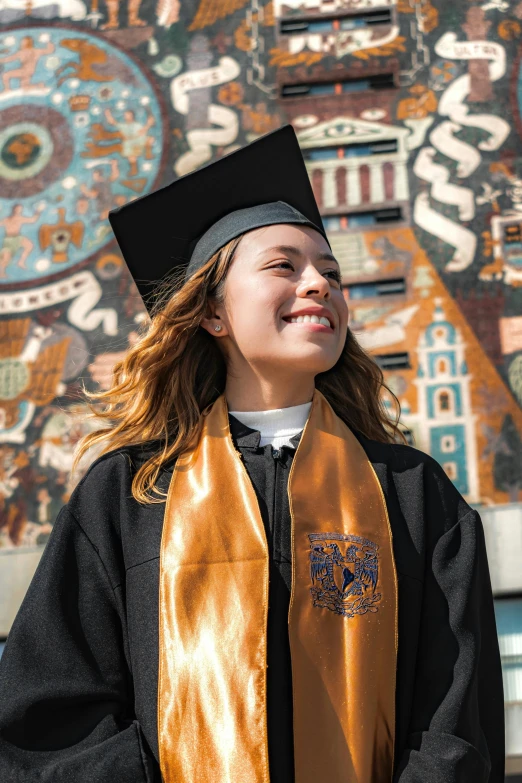 the graduate looks off into the distance at graduation