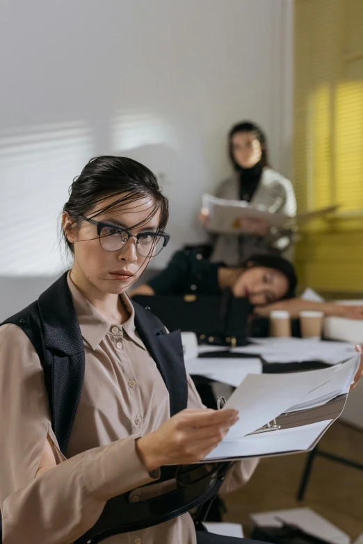 two people in an office with paperwork in front of them