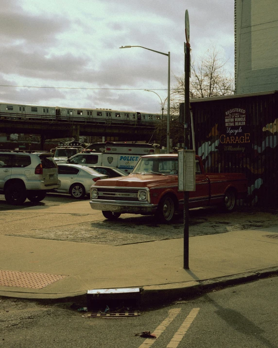 a view of cars parked near a large graffiti covered building