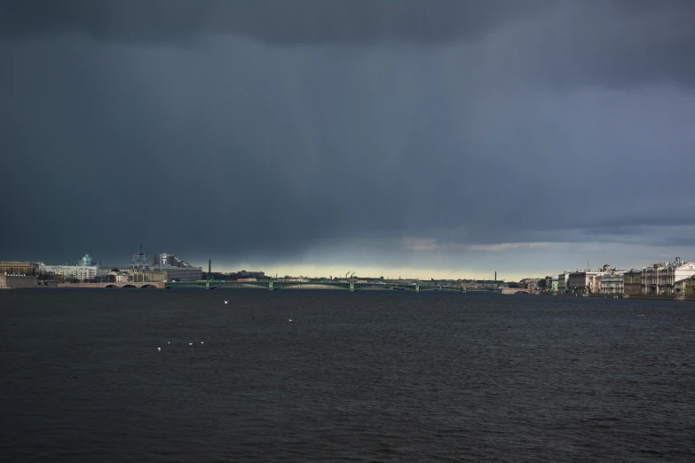 rain is pouring in the background over some cityscape