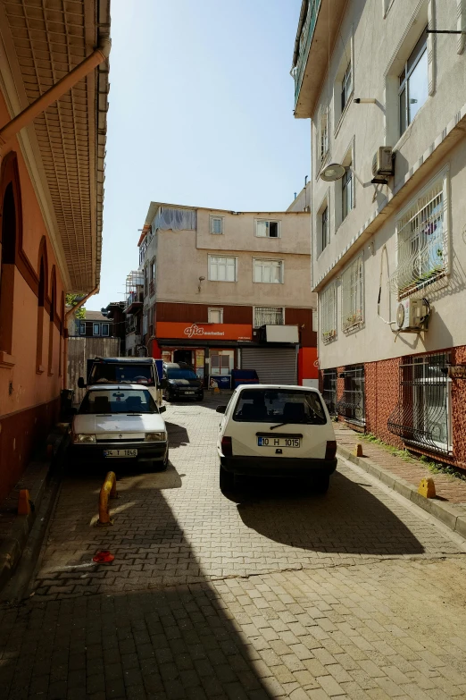 three cars that are sitting on a street