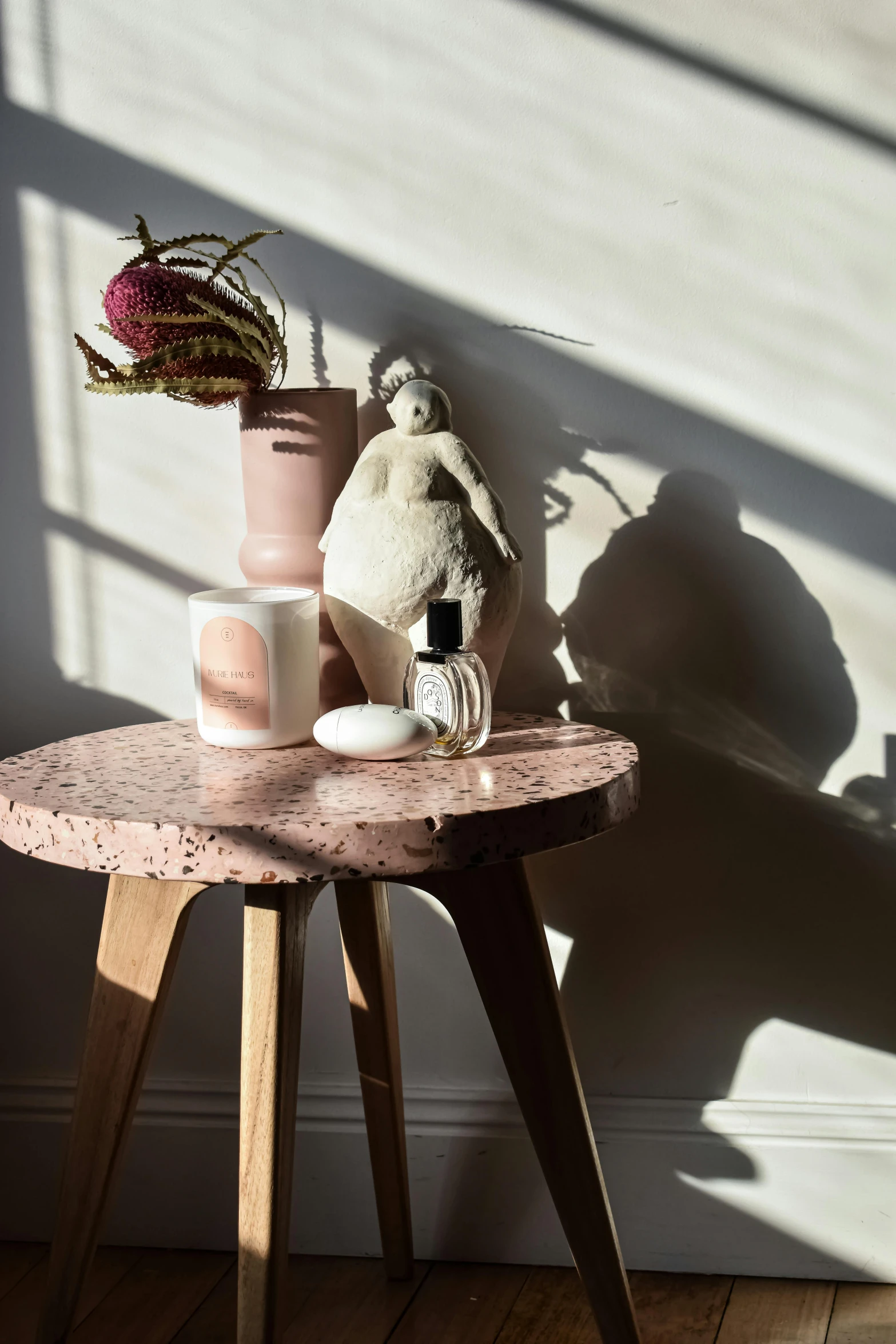 a table with a vase and other items on top of it