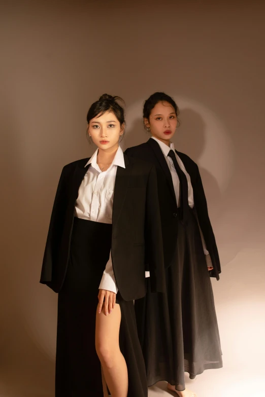 two models dressed in business attire with black skirt