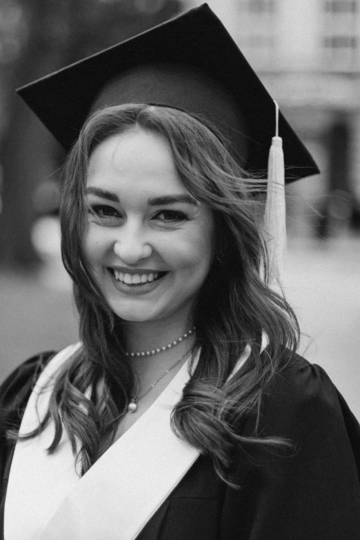 a smiling student in her cap and gown