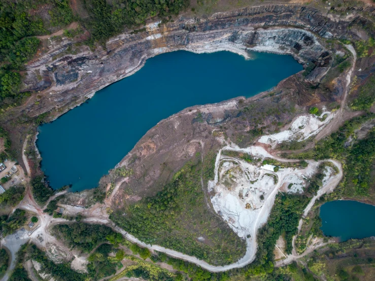 an aerial s of a lake surrounded by trees