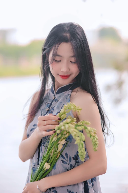 a woman is looking down at her bouquet