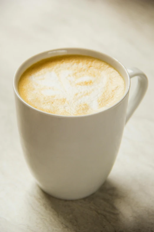 a close up of a cup of coffee with steam