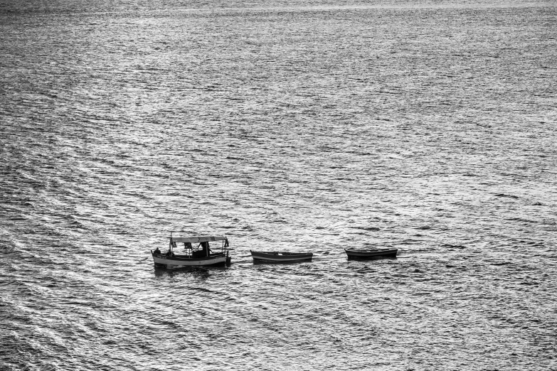 two boats are on the water off in the distance