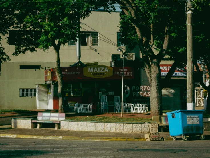 a group of chairs sitting next to trees and a road