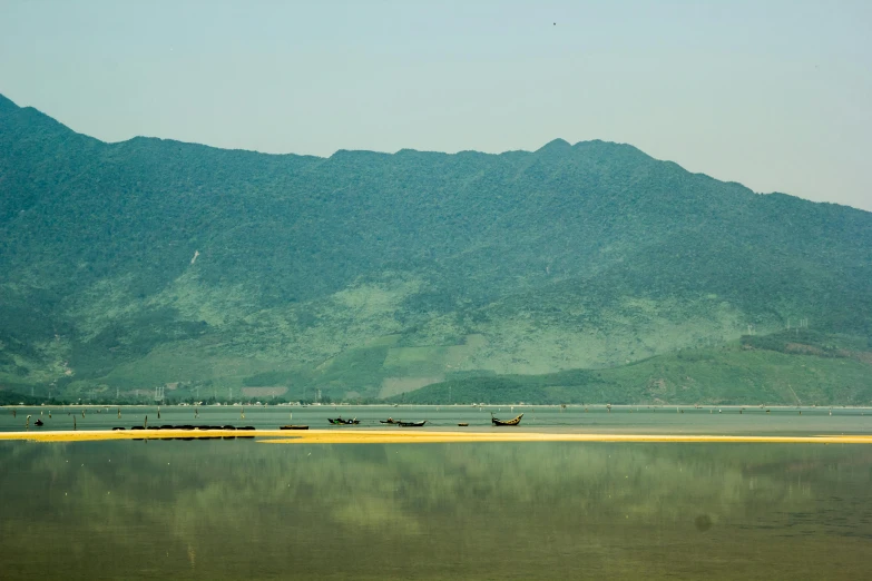 a mountain range reflected in the still water of a lake