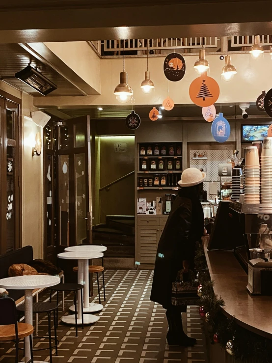 a small restaurant with many lights above the counter