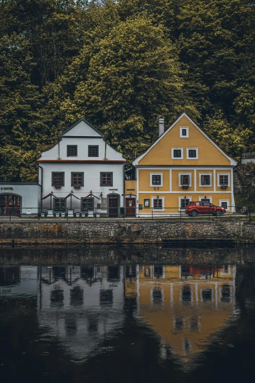 some houses on the side of a body of water