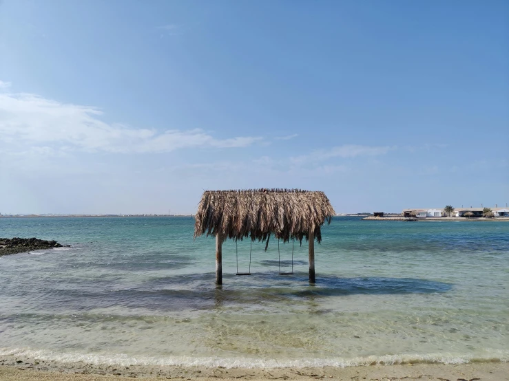 a shelter sitting on top of a sandy beach