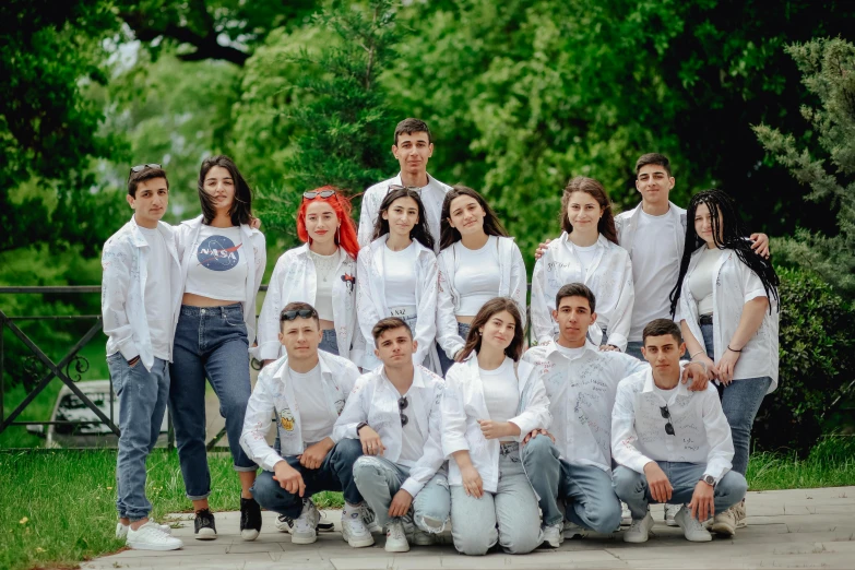 a group of people standing together on the sidewalk