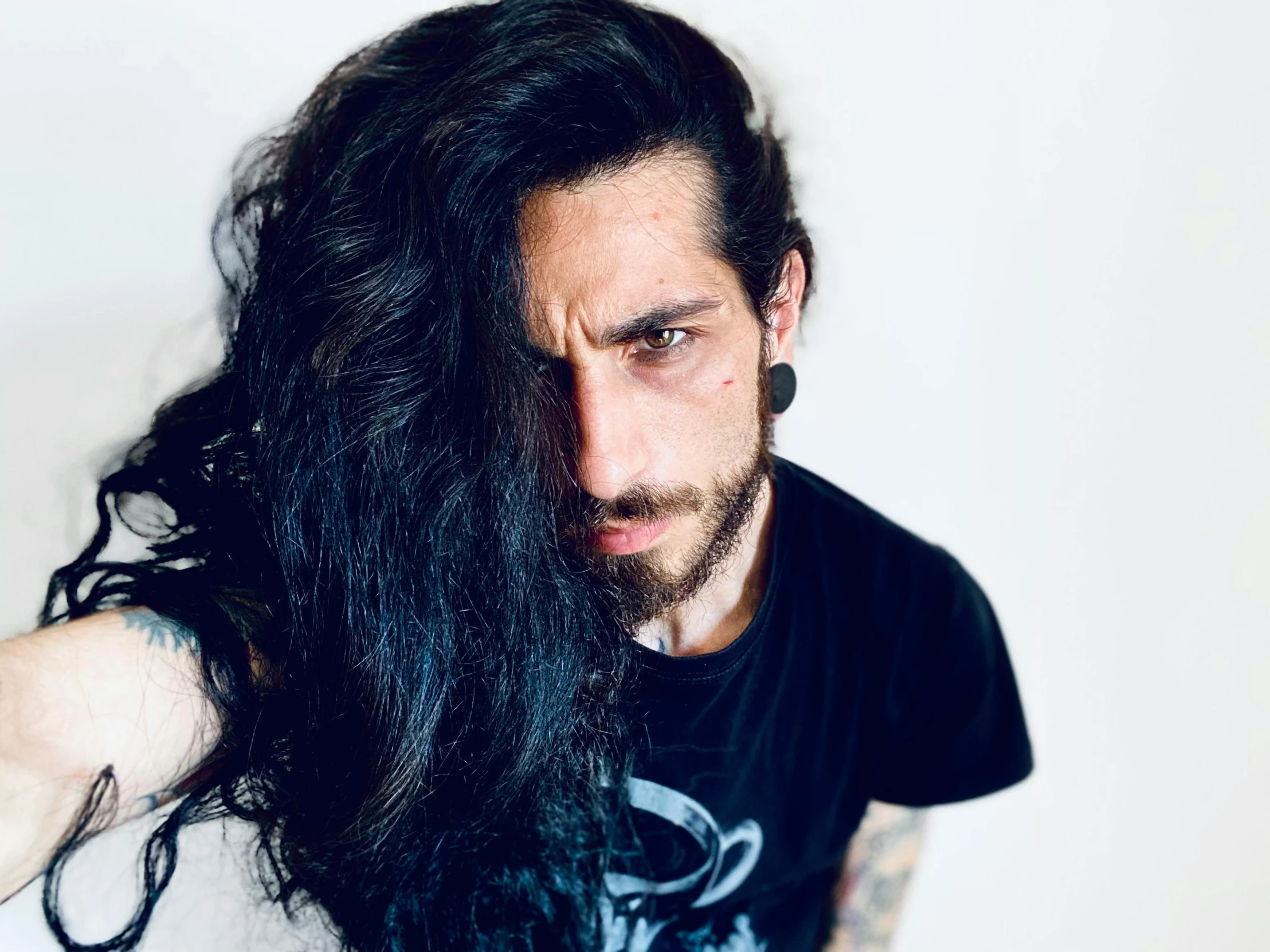 a man with long dark hair and a beard