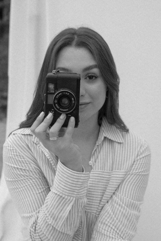 a black and white po of a person taking a po with a camera