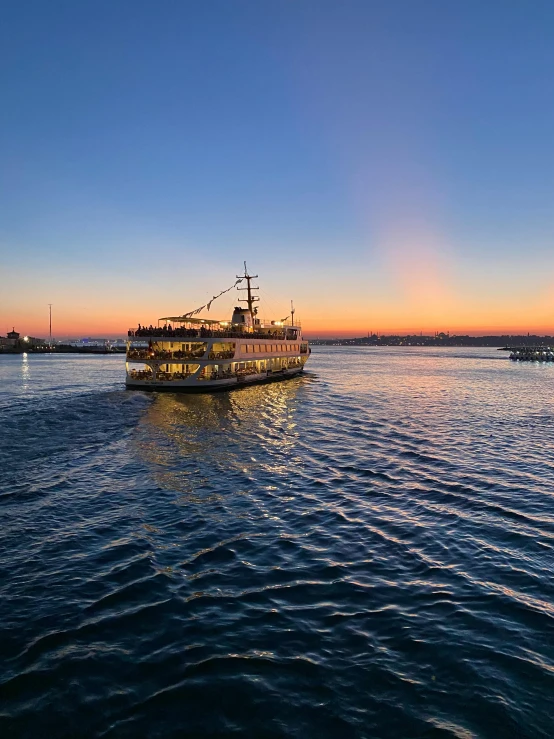 an old boat out on the water at sunset