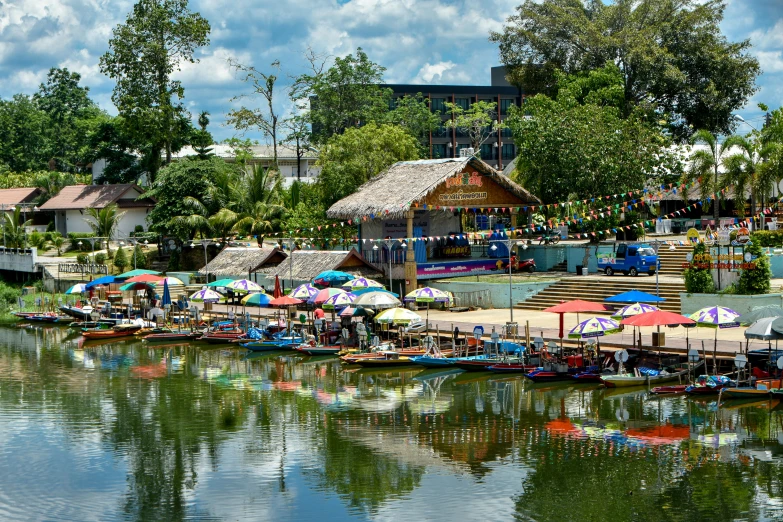 a river has boats lined up with umbrellas on top